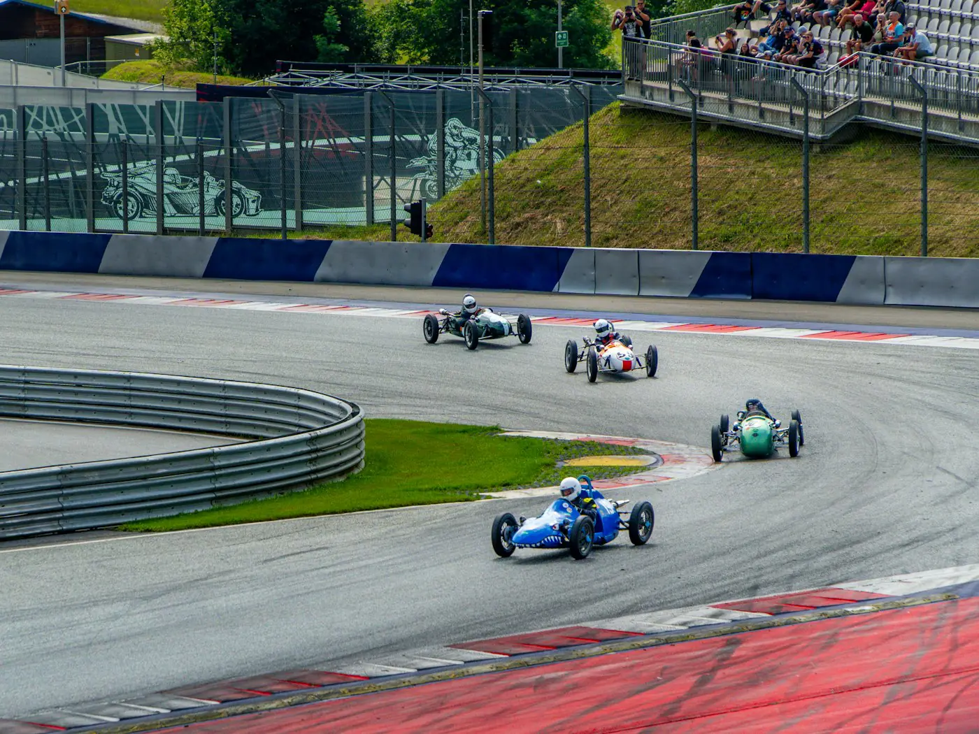 Vintage single-seater racing cars cornering on a circuit